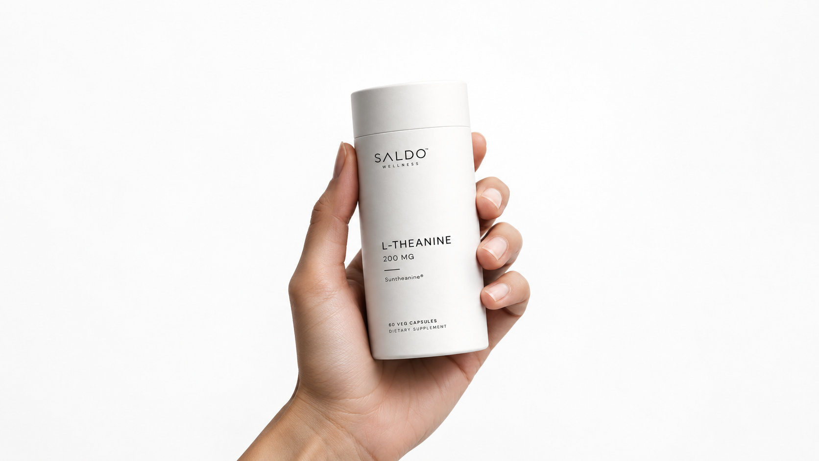 A hand holding a Saldo Wellness L-Theanine bottle